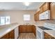 Kitchen with wood cabinets, white appliances, and breakfast bar at 13441 Calloway Glen Dr, Charlotte, NC 28273