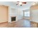 Living room with hardwood floors, fireplace, and built-in shelving at 13441 Calloway Glen Dr, Charlotte, NC 28273