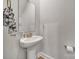 Small powder room with pedestal sink and gold accents at 179 Tanner Loop, Troutman, NC 28166