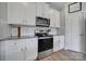 Modern kitchen with white cabinets, granite countertops, and stainless steel appliances at 179 Tanner Loop, Troutman, NC 28166