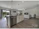 Modern kitchen with island and stainless steel appliances at 179 Tanner Loop, Troutman, NC 28166