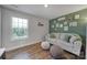 Cozy living area with light-grey sofa and green accent wall at 179 Tanner Loop, Troutman, NC 28166