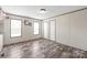 Bedroom with neutral walls, two windows, and wood-look flooring at 1805 Drew Dr, Lincolnton, NC 28092