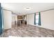 Open concept living room with dark wood floor flowing into the kitchen with a center island at 1805 Drew Dr, Lincolnton, NC 28092