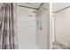 The shower has a shower head, seat, and curtain with a brown floral pattern at 1805 Drew Dr, Lincolnton, NC 28092