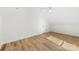 Attic bedroom featuring wood-look floors, white trim, and a ceiling fan at 210 S Millon St, Gastonia, NC 28052