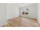 Cozy bedroom featuring wood-look floors, a ceiling fan, and a bright window view at 210 S Millon St, Gastonia, NC 28052