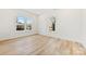 Well-lit bedroom with wood-look flooring, two windows, and a neutral color palette at 210 S Millon St, Gastonia, NC 28052