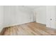 Minimalist bedroom with wood-look flooring, white walls, and plenty of natural light at 210 S Millon St, Gastonia, NC 28052