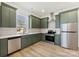 Modern kitchen with stainless steel appliances and light green cabinets at 210 S Millon St, Gastonia, NC 28052