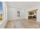 Bright, open living room with wood-look floors and a view into the kitchen with green cabinets at 210 S Millon St, Gastonia, NC 28052