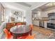 Modern dining room with a round table and four orange chairs at 2601 Columbus Cir, Charlotte, NC 28208