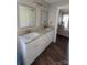 Double vanity bathroom with granite countertop and view of bedroom at 34466 Lisa Dr, Albemarle, NC 28001