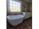 Spa-like bathroom with freestanding tub and large window at 34466 Lisa Dr, Albemarle, NC 28001