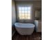 Bathroom with soaking tub, double vanity, and large window at 34466 Lisa Dr, Albemarle, NC 28001