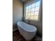 Modern bathroom with freestanding tub, double vanity, and large mirror at 34466 Lisa Dr, Albemarle, NC 28001