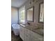 Elegant bathroom with double vanity, soaking tub, and hardwood floors at 34466 Lisa Dr, Albemarle, NC 28001