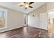 Bright bedroom featuring hardwood floors, ceiling fan, and wooded views at 34466 Lisa Dr, Albemarle, NC 28001