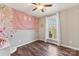 Bedroom with ceiling fan, hardwood floors, and window at 34466 Lisa Dr, Albemarle, NC 28001