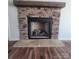 Stone fireplace with a rustic wooden mantel at 34466 Lisa Dr, Albemarle, NC 28001