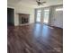 Spacious living room with hardwood floors and a stone fireplace at 34466 Lisa Dr, Albemarle, NC 28001