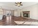 Open concept living space with hardwood floors, fireplace, and kitchen views at 34466 Lisa Dr, Albemarle, NC 28001