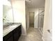 Bathroom with granite countertops, dark cabinets, and shower at 3628 Benseval Ln, Matthews, NC 28104