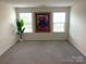 Bright bedroom with neutral carpeting and large windows at 3628 Benseval Ln, Matthews, NC 28104