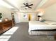 Spacious main bedroom with king-size bed and ceiling fan at 3628 Benseval Ln, Matthews, NC 28104