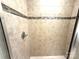 Shower with beige tile and decorative mosaic accents at 3628 Benseval Ln, Matthews, NC 28104