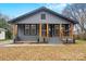 Renovated gray house with a front porch and landscaping at 4421 Gum St, Charlotte, NC 28208