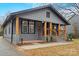 Gray house with wood columns and a landscaped yard at 4421 Gum St, Charlotte, NC 28208