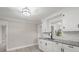 Bright kitchen boasts white cabinets, granite countertops, and a stylish faucet at 4421 Gum St, Charlotte, NC 28208