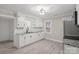 Renovated kitchen features white cabinets, granite countertops, and modern appliances at 4421 Gum St, Charlotte, NC 28208