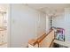 Upstairs hallway with wooden railing and access to closets at 447 Nc 16 S Hwy, Taylorsville, NC 28681