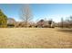 Large backyard with mature trees and home view at 5023 Ancestry Cir, Matthews, NC 28104