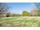 Large backyard with mature trees and partial fence at 5023 Ancestry Cir, Matthews, NC 28104