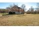 Large backyard with mature trees and home view at 5023 Ancestry Cir, Matthews, NC 28104