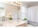 Bright bathroom with double sinks, mirror, and window at 5023 Ancestry Cir, Matthews, NC 28104