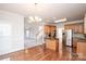 Kitchen with island, stainless steel appliances, and hardwood floors at 5023 Ancestry Cir, Matthews, NC 28104