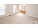 Living area with neutral carpet and hardwood floors at 5023 Ancestry Cir, Matthews, NC 28104