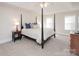 Spacious main bedroom with a post bed, ceiling fan, and ample natural light at 5023 Ancestry Cir, Matthews, NC 28104