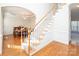 Elegant staircase with wood railing and carpeted steps at 5023 Ancestry Cir, Matthews, NC 28104