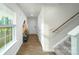 Bright hallway with wood-look flooring and a staircase leading to the upper level at 5063 Beargrass Dr, Dallas, NC 28034