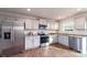 Bright kitchen with stainless steel appliances, light gray cabinetry and granite countertops at 5063 Beargrass Dr, Dallas, NC 28034