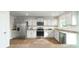 Well-lit kitchen featuring stainless steel appliances, granite countertops, and wood-look flooring at 5063 Beargrass Dr, Dallas, NC 28034