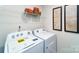 Laundry area includes modern washer and dryer plus decorative shelving and artwork at 5063 Beargrass Dr, Dallas, NC 28034