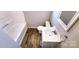 Bright bathroom featuring a tub, sink, vanity and wood-look floors at 5917 Peach St, Charlotte, NC 28269