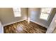 Sunlit bedroom features attractive laminate flooring and two bright windows at 5917 Peach St, Charlotte, NC 28269