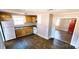 Compact kitchen with wood cabinets and updated appliances with view to front door at 5917 Peach St, Charlotte, NC 28269